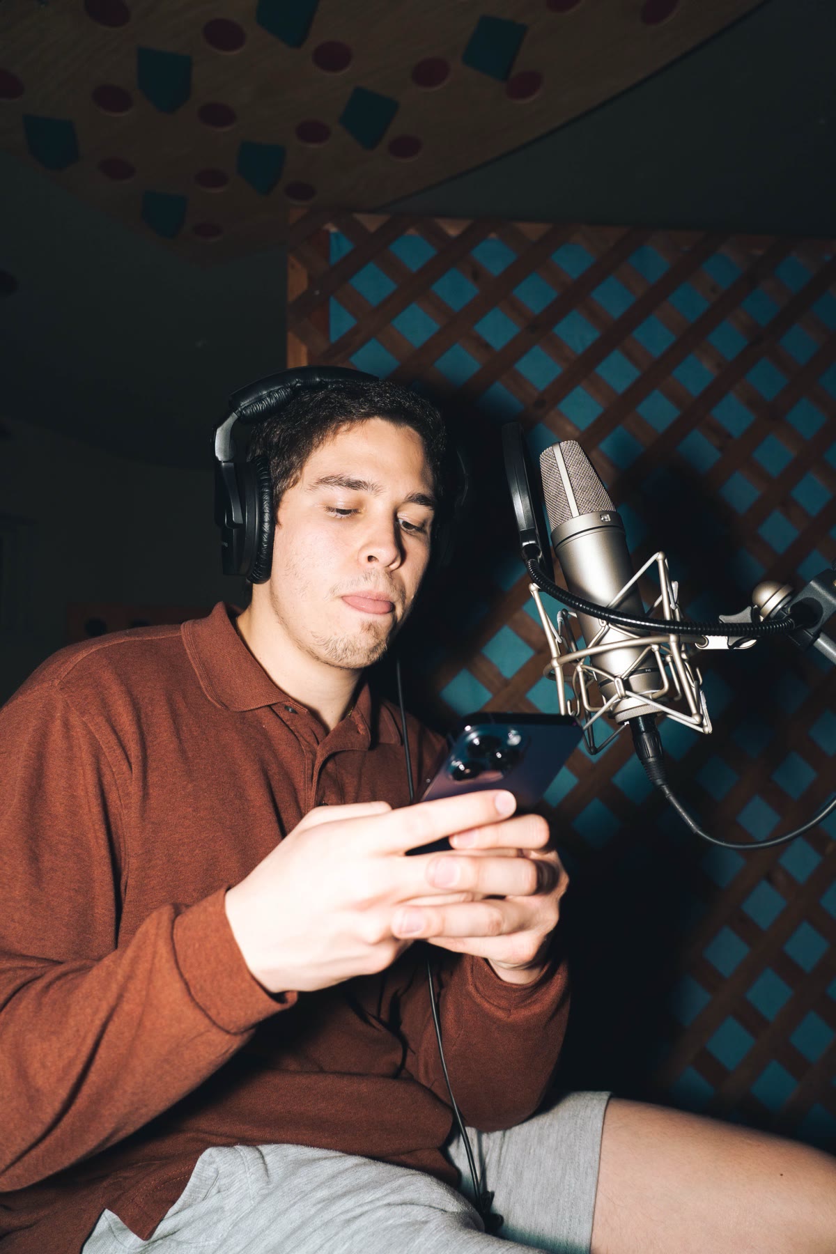 Nate Sanway wearing headphones at a studio microphone