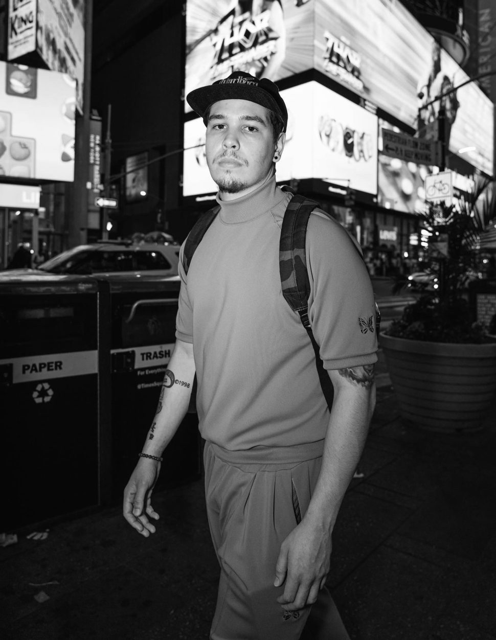 Black and white portrait of Nate Sanway in Times Square at night